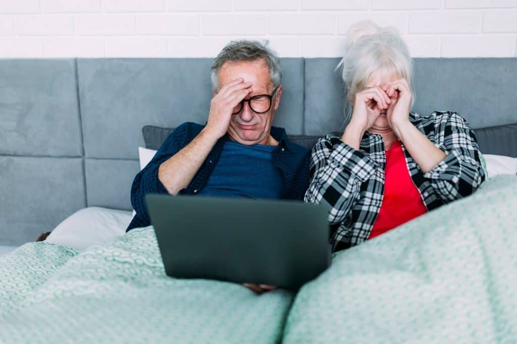 Seniors watching show from laptop and can't sleep as retirement affects sleep