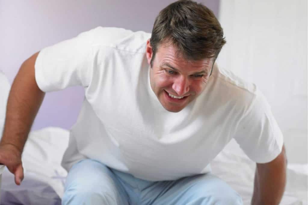 Man waking up with chronic pain