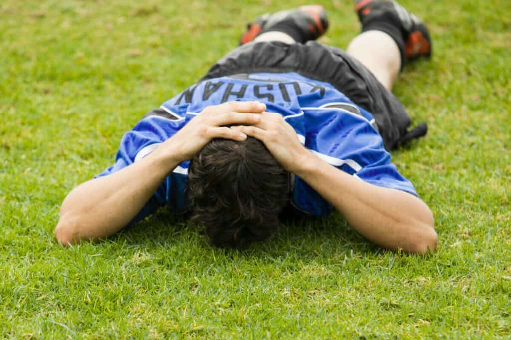 soccer player lying on the field