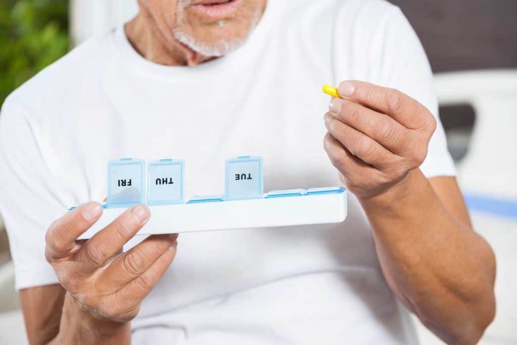 Old man with dementia choosing his medication