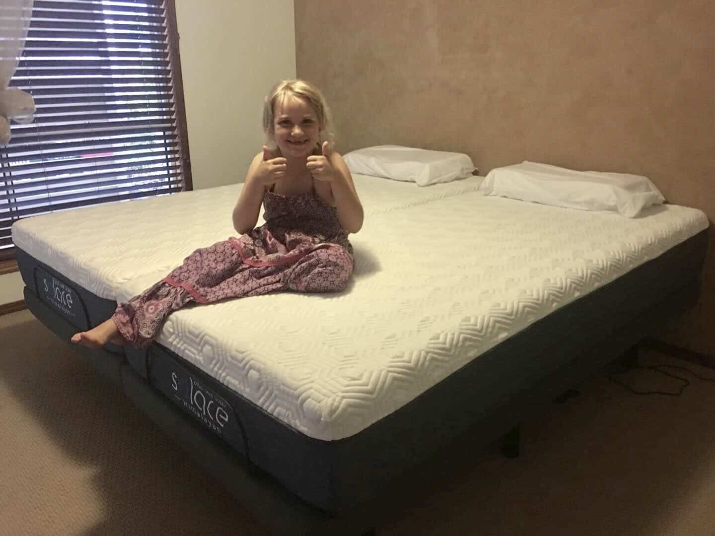 Solace Sleep adjustable bed review with little girl thumbs up