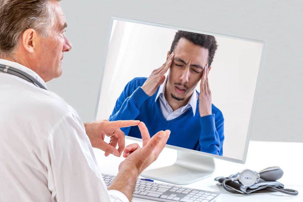 man talking to doctor about fibromyalgia